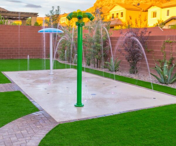 Colorful splash pad in backyard setting