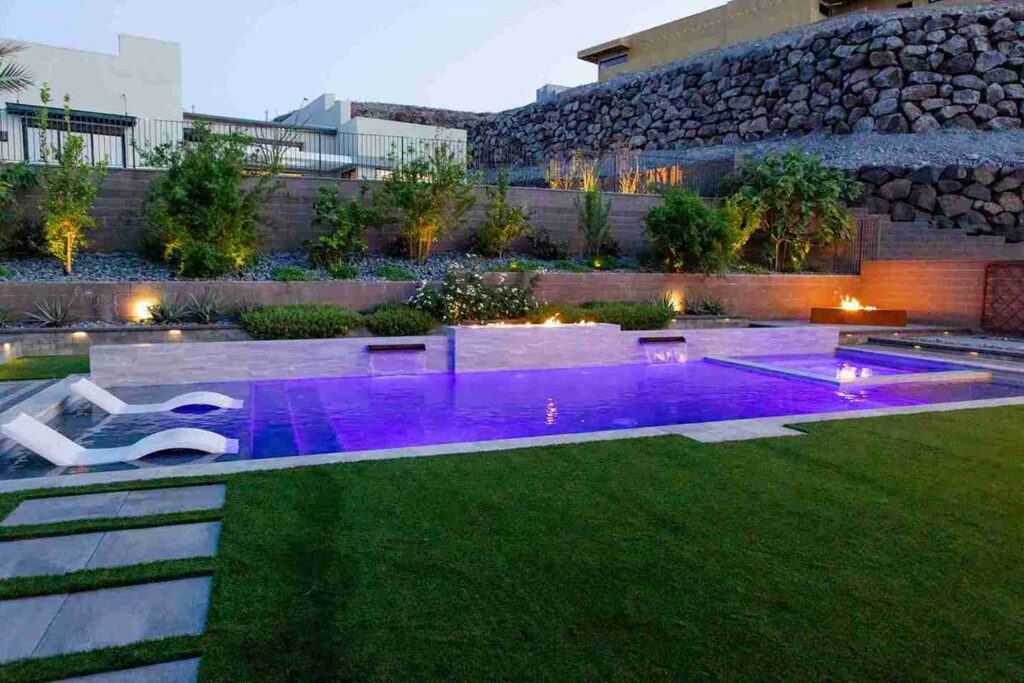 A beautiful backyard oasis showcasing a pool, fire pit, and cozy outdoor seating area, ideal for enjoying warm evenings.