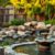 A tranquil backyard oasis featuring a fountain surrounded by a lush garden and a serene rock garden.
